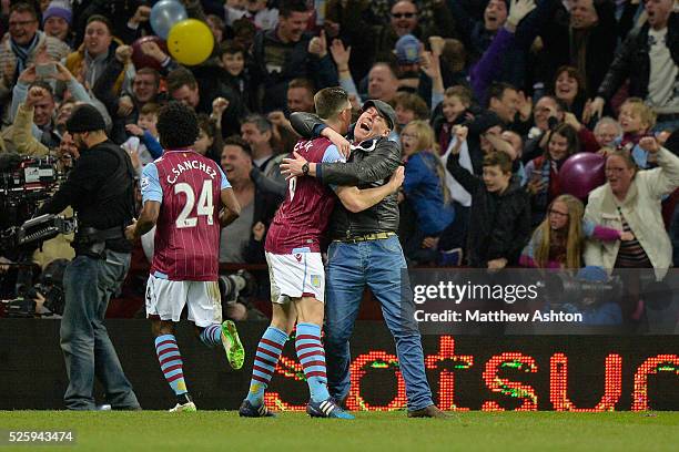 A Aston Villa fan hugs Ciaran Clark of Aston Villa after Scott Sinclair of Aston Villa scores a goal to make it 2-0