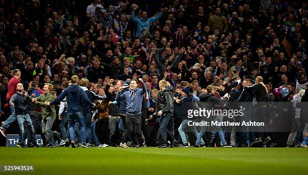 A Aston Villa fans invade the pitch during the match after Scott Sinclair of Aston Villa scores a goal to make it 2-0