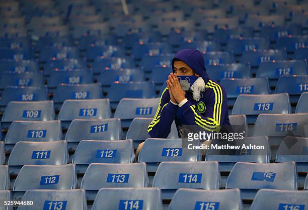 Dejected looking Chelsea fan at the end of the match wearing a scarf with the European Cup on it