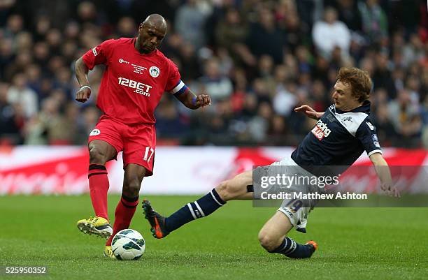 Chris Taylor of Millwall tackles Emmerson Boyce of Wigan Athletic