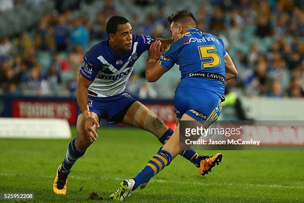 Clinton Gutherson of the Eels evades the tackle of Will Hopoate of the Bulldogs during the round nine NRL match between the Parramatta Eels and the...