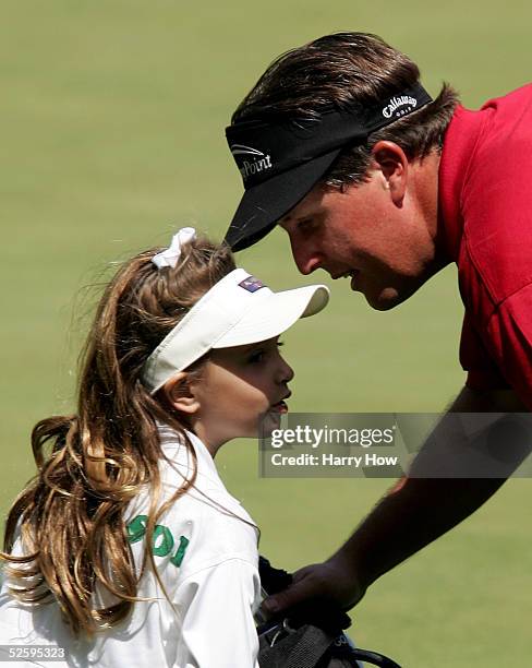 Phil Mickelson talks to his daughter, Amanda, on the ninth green during the Par-3 contest at The Masters at the Augusta National Golf Club on April...