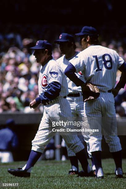 Manager Leo Durocher of the Chicago Cubs heads towards home plate and the umpire as Thirdbaseman Ron Santo and secondbaseman Glenn Beckert) watch...