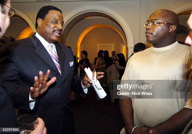 Fox NFL sportscaster James Brown talks with player Will Shields and other guests at the JB Awards Welcome Reception April 6, 2005 in Washington, DC.