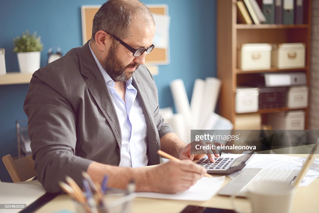 Mature Adult man working in the office