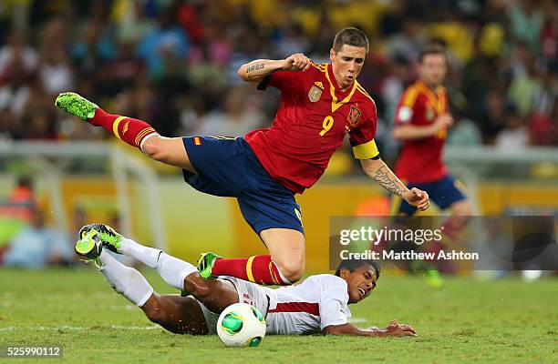 Jonathan Tehau of Tahiti fouls Fernando Torres of Spain