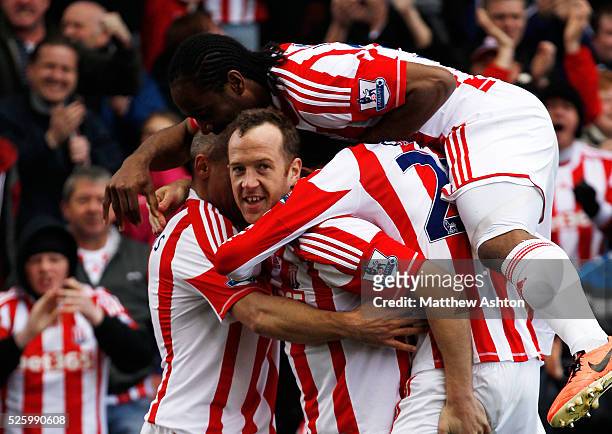 Charlie Adam of Stoke City is mobbed by his team-mates after scoring a goal to make it 1-0