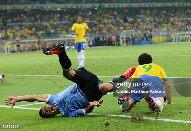 Luis Suarez of Uruguay collides with Fred of Brazil but no penalty was given