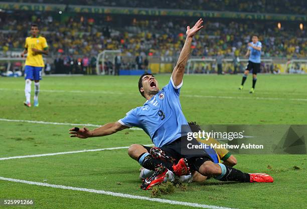 Luis Suarez of Uruguay collides with Fred of Brazil but no penalty was given