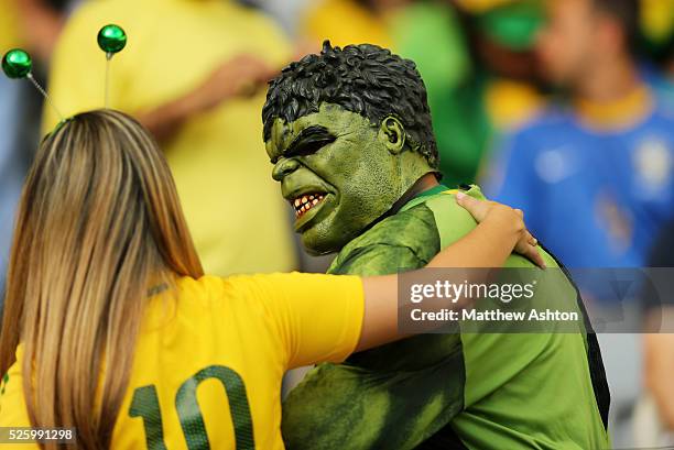 Fan dressed as Hulk meets a female fan of Brazil