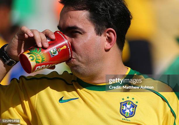 Fan of Brazil drinks out of a FIFA 2013 Confederations Cup cup