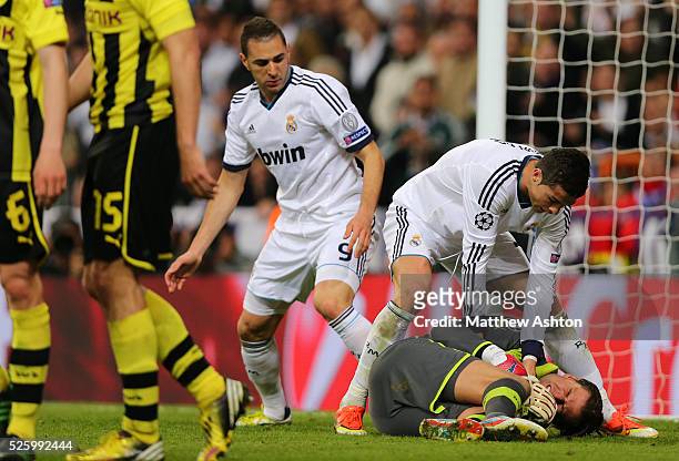 Roman Weidenfeller of Borussia Dortmund holds on to the ball as Cristiano Ronaldo of Real Madrid tries to get it off him following the first goal
