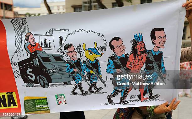 Protestors carry a banner outside the Estadio Jornalista Mario Filho / Maracana Stadium in Rio de Janeiro, Brazil to protest about the Police Raid on...