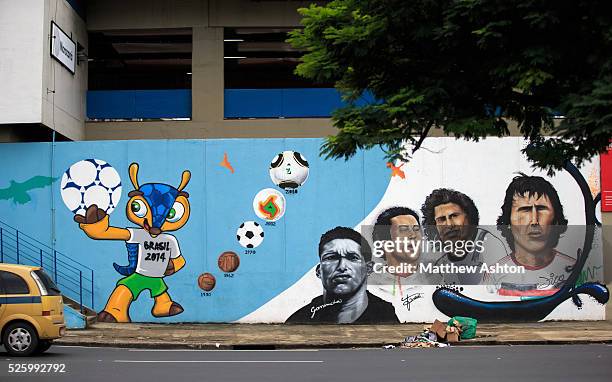 Traffic passes a football mural painting on the wall of the Maracana Metro, serving the Estadio Jornalista Mario Filho / Maracana Stadium in Rio de...