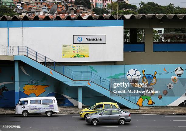 Traffic passes a football mural painting on the wall of the Maracana Metro, serving the Estadio Jornalista Mario Filho / Maracana Stadium in Rio de...