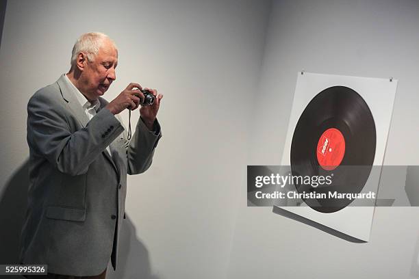 Artist Hans-Peter Feldmann takes a picture of his work during the preview of the exhibitions 'Hans-Peter Feldmann - retrospective' and 'Talents 37 -...