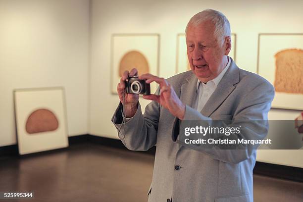 Artist Hans-Peter Feldmann takes a picture of his work during the preview of the exhibitions 'Hans-Peter Feldmann - retrospective' and 'Talents 37 -...