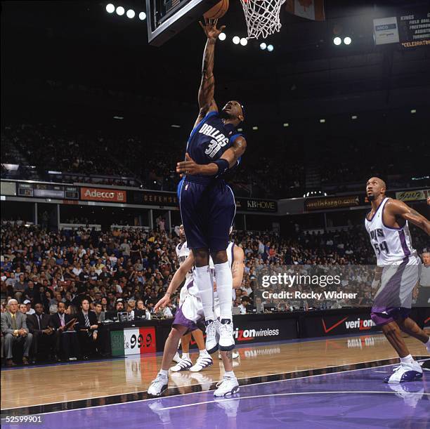 Jason Terry of the Dallas Mavericks puts a shot up against the Sacramento Kings at ARCO Arena on March 24, 2005 in Sacramento, California. The Kings...