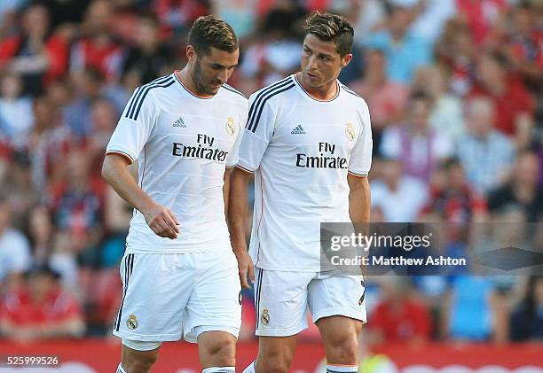 Cristiano Ronaldo of Real Madrid speaks with Karim Benzema of Real Madrid