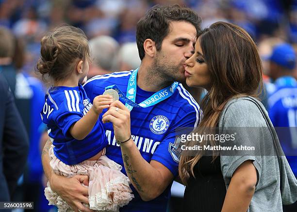 Cesc Fabregas of Chelsea kisses partner Daniella Semaan as he holds their daughter Lia