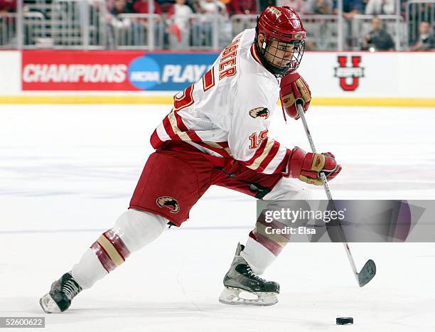 Forward Jon Foster of the Denver Pioneers moves the puck against the Colorado College Tigers on April 7, 2005 during the NCAA Frozen Four at Value...