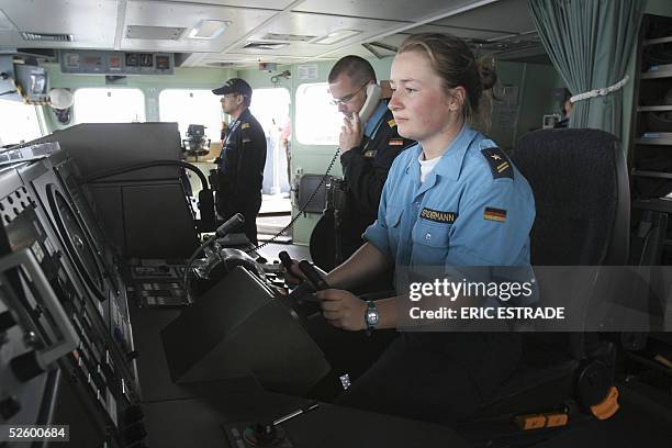 German sailor mans the helm of the destroyer Sachesen off the southern French coast 07 April 2005 participating in the joint maneuvre "Trident d'Or...