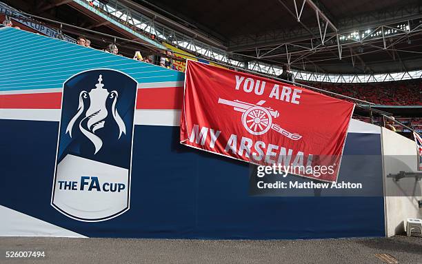 An Arsenal flag next to the FA Cup sign / branding