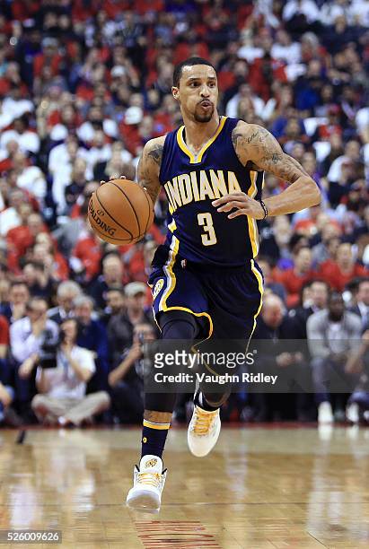George Hill of the Indiana Pacers dribbles the ball in the first half of Game Five of the Eastern Conference Quarterfinals against the Toronto...