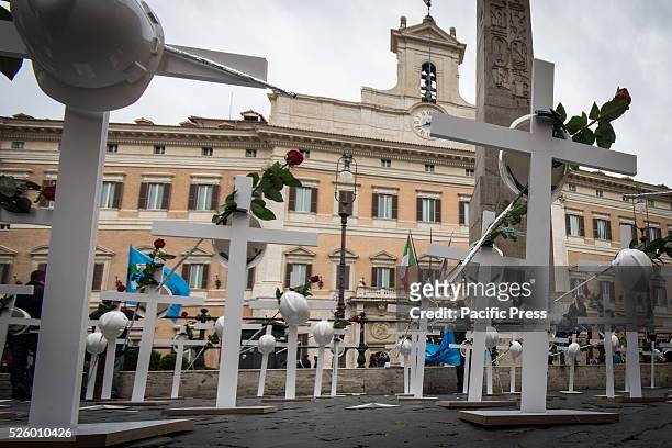 Crosses, 100 helmets and 100 red roses were placed in Piazza Montecitorio in Rome by category Feneal Uil unions, Filca Cisl and Cgil Fillea on the...