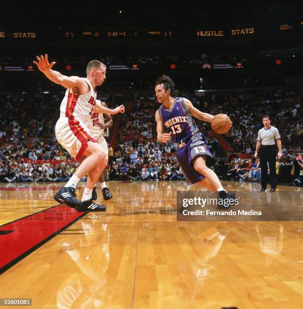 Steve Nash of the Phoenix Suns drives to the basket against Michael Doleac of the Miami Heat during a game at American Airlines Arena on March 25,...