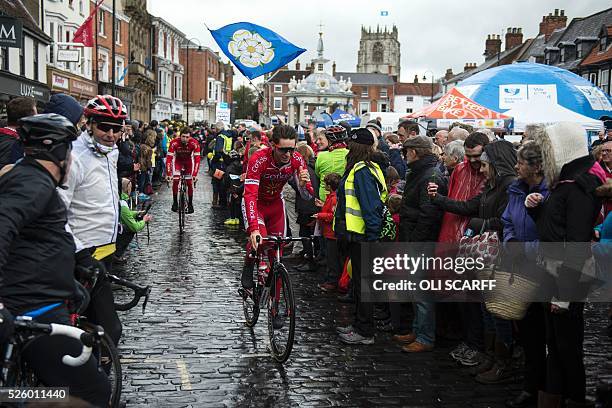 French cyclist Anthony Turgis, riding for team Cofidis, leads a teammate to the start line to compete in the first stage of the Tour de Yorkshire, in...