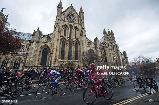 Cyclists ride past Beverley Minster as they compete in the first stage of the Tour de Yorkshire, in Beverley, north east England, on April 29, 2016....