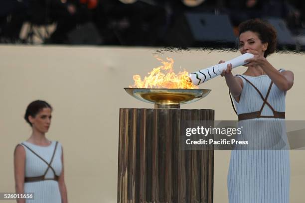 High Priestess Katerina Lechou lights the Cauldron with the Olympic Torch. Hellenic Olympic Committee organized the Handover Ceremony for the Olympic...