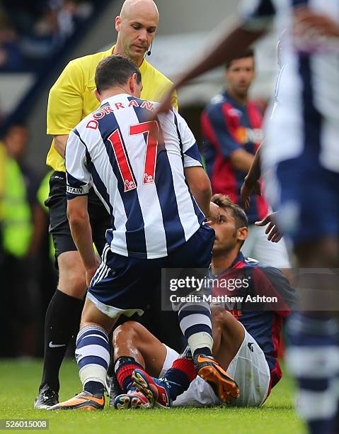 Michele Pazienza of Bologna gets kicked by Graham Dorrans of West Bromwich Albion