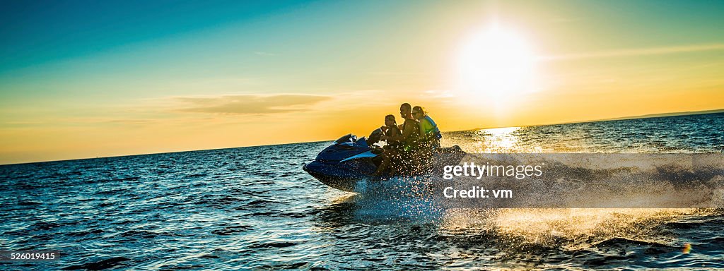 Family Riding  Jet Boat at Sunset