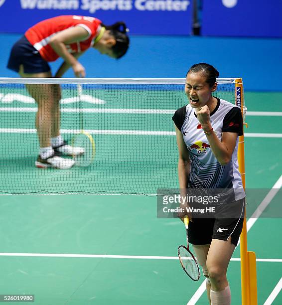 Wang Yihan of China celebrates after defeating Nozomi Okuhara of Japan during their women's singles match at the 2016 Badminton Asia Championships on...