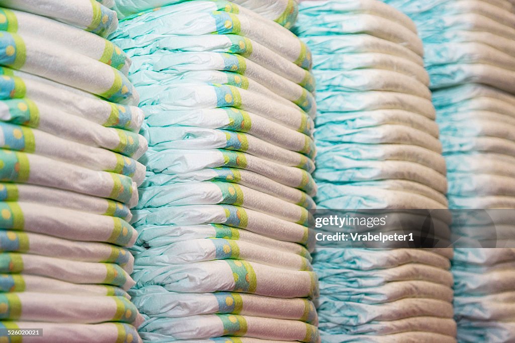 Children's diapers stacked in a piles