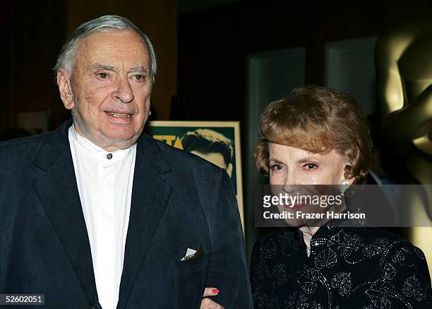 Actress Joan Leslie poses with Gore Vidal author at the Academy of Motion Picture Arts and Sciences Centennial tribute to Oscar-winning actress Greta...