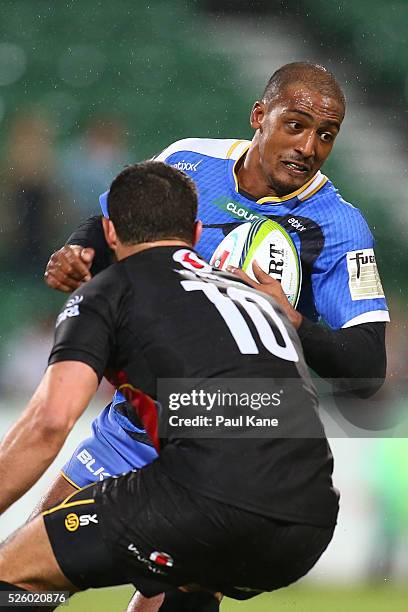 Marcel Brache of the Force looks to avoid being tackled by Francois Brummer of the Bulls during the round 10 Super Rugby match between the Force and...