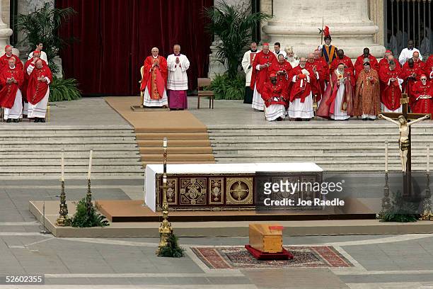 Cardinal Joseph Ratzinger prays during the funeral for Pope John Paul II in St. Peter's Square April 8, 2005 in Vatican City, Vatican. Cardinals...