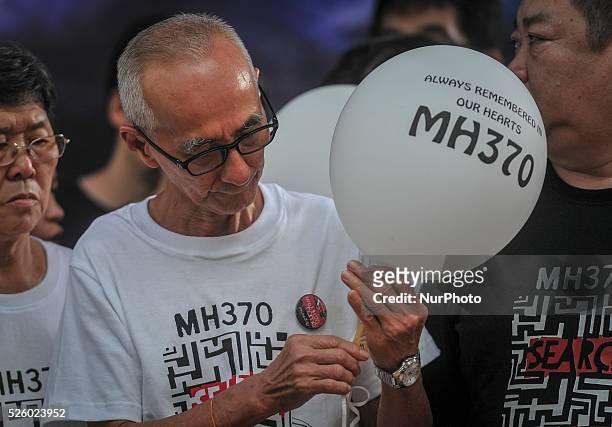 Family member of a passenger who was onboard the missing Malaysia Airlines flight MH370 Holds a Balloon with the names of those who were on board...