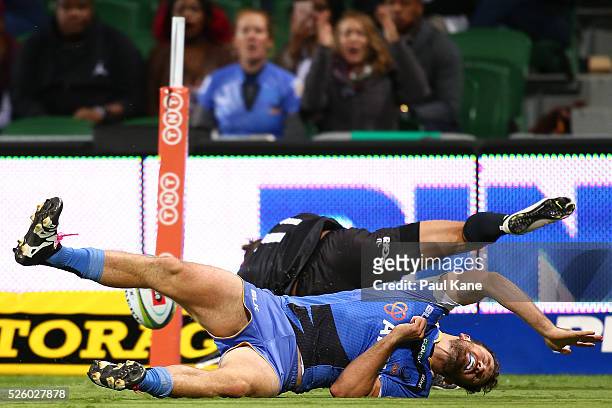 Luke Morahan of the Force tangles with Bjorn Basson of the Bulls over the try line during the round 10 Super Rugby match between the Force and the...