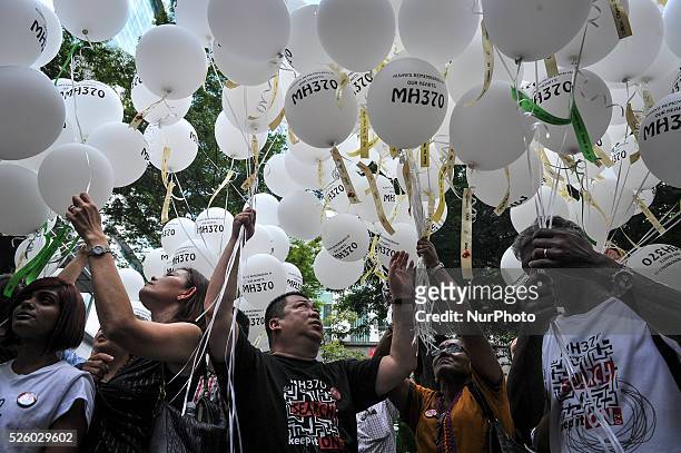 Family members of passengers onboard the missing Malaysia Airlines flight MH370 release balloons with the names of those who were on board during a...