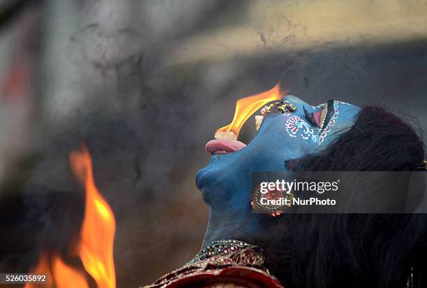 An indian artist, dressed as Hindu goddess Shakti, performs during Maha ShivaRatri festival,celebrated in reverence of the God Shiva,married to Hindu...