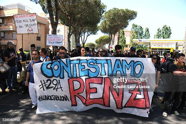 People protest against Italian prime Minister Matteo Renzi with a banner that says 'Contestiamo Renzi' after the celebration of the 30th anniversary...