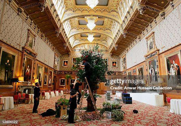 Flowers are arranged in the Waterloo Chamber in Windsor Castle for tomorrow's reception following the royal wedding tomorrow between the Prince of...