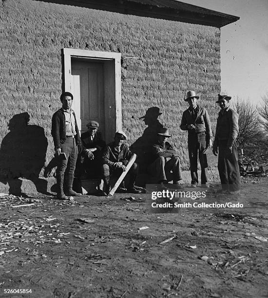 Black and white photograph of a group of men standing in front of a building, titled "Surveying gang, WPA Workers, Bosque Farms Project", by Dorothea...