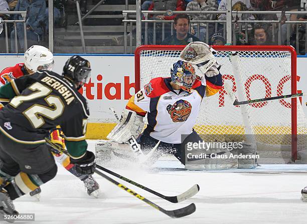 Blast by Aaron Berisha of the London Knights goes off the crossbar behind Devin Williams of the Erie Otters during game four of the OHL Western...