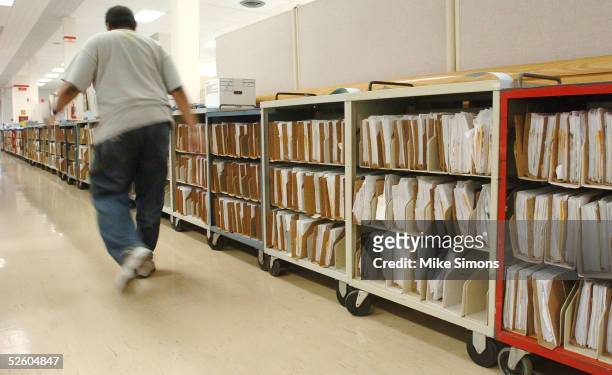 An employee at the Cincinnati Internal Revenue Service Center makes their way past the returns waiting to be processed April 8, 2005 in Covington,...