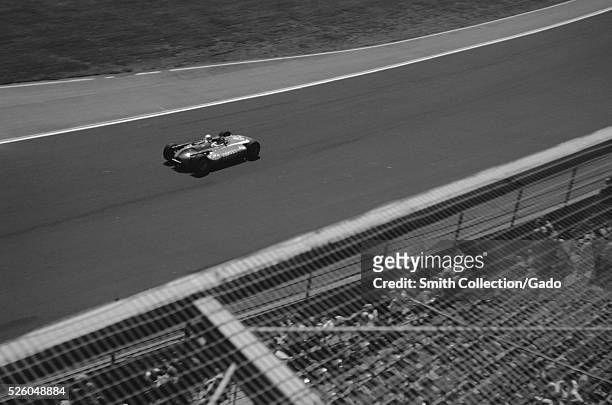 Race car driver Masten Gregory driving car 82, made by MT Harvey, during a qualifying lap for the Indianapolis 500 race at Indianapolis Motor...